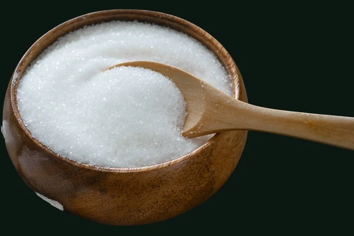 Cambya: a fine white granular sweetener in a wooden bowl, with a wooden spoon